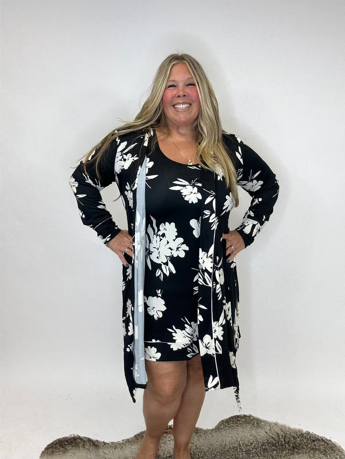 Black tank dress with white floral print and matching long cardigan, modeled against white background