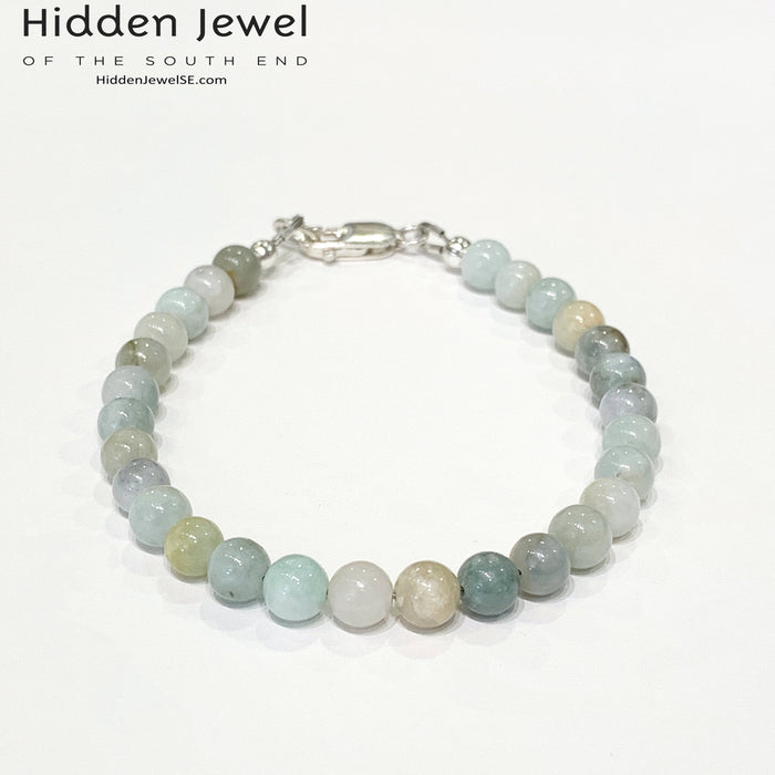 A Burma jade gemstone beaded bracelet with sterling silver  lobster claw on white background, front close up overview.