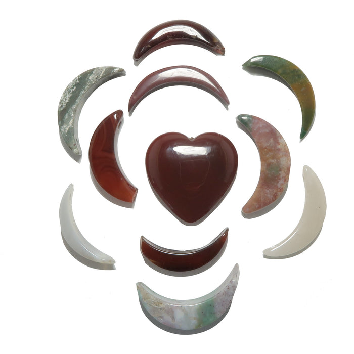 Decorative stone heart with curved stone pieces arranged in a circular pattern on a white background