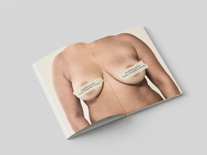 The Chests book open to a portrait of a bare chest with the nipples covered by the subject's printed quote