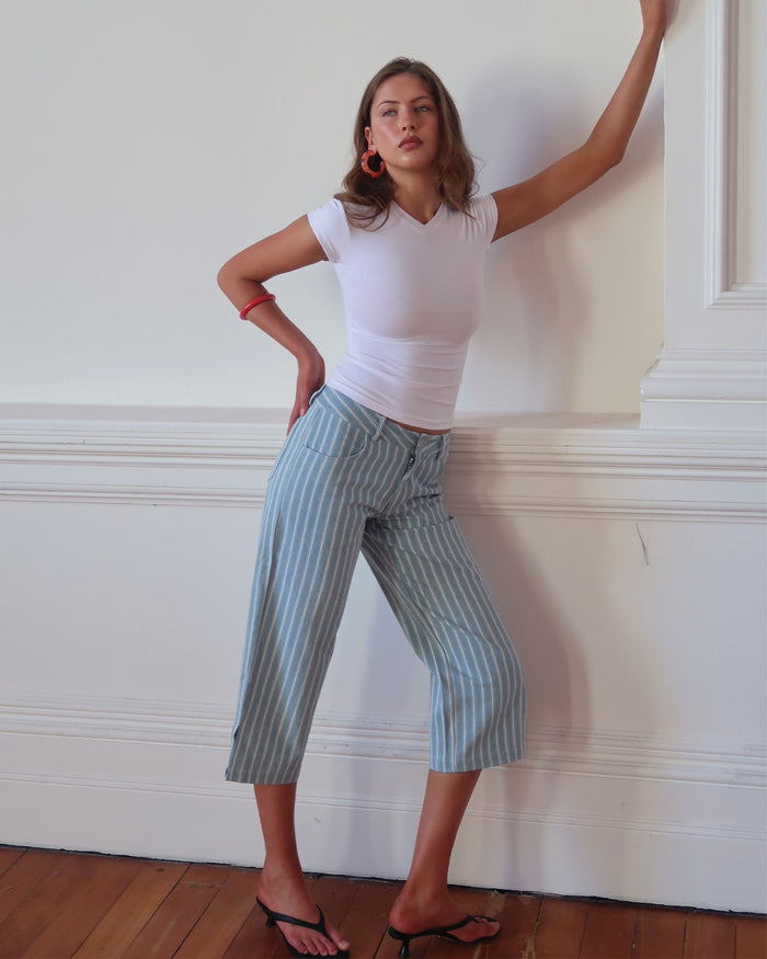 Women's low waisted pant in denim stripe featuring 3/4 length and straight leg fit.