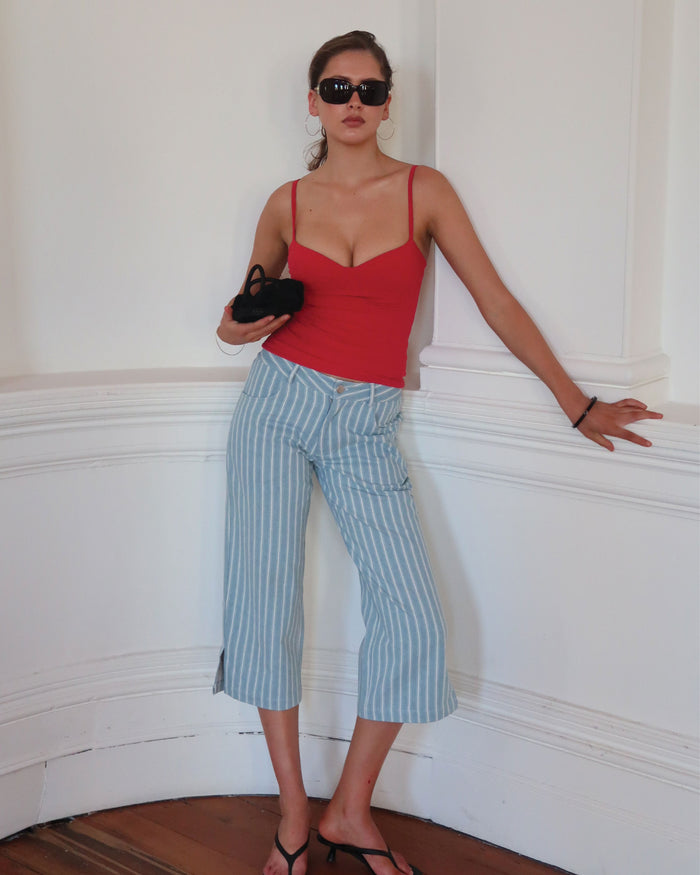 Women's low waisted pant in denim stripe featuring 3/4 length and straight leg fit.