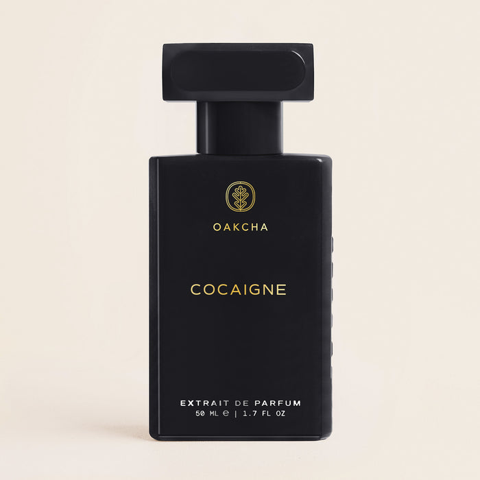 Front view of black Oakcha Cocaigne Extrait de Parfum bottle with rectangular cap, 50 mL, 1.7 FL OZ, and light background