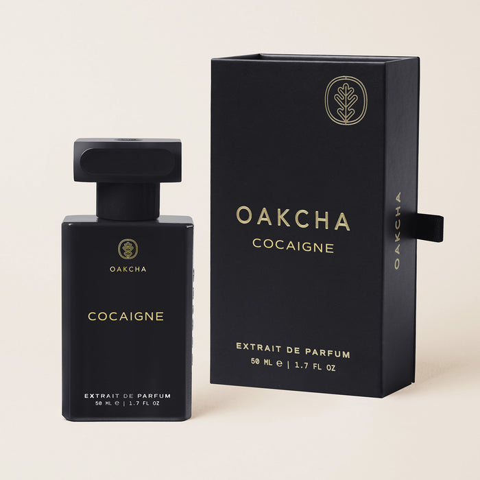 Front view of Cocaigne Extrait de Parfum bottle and box showcasing black packaging and 50 ml size against a light background