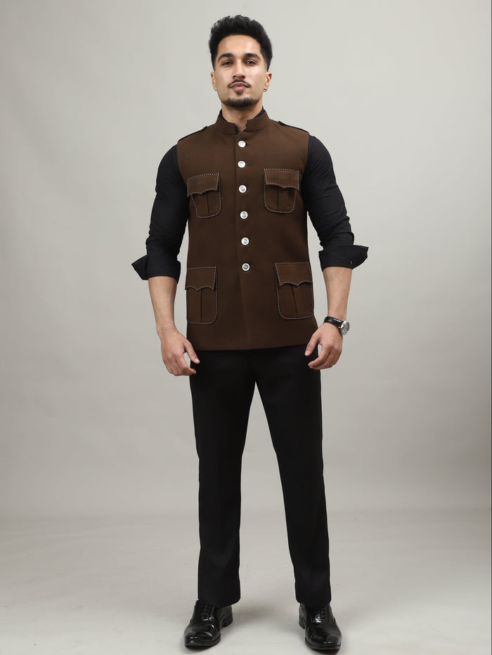 Man wearing a brown vest over a black shirt on a white background