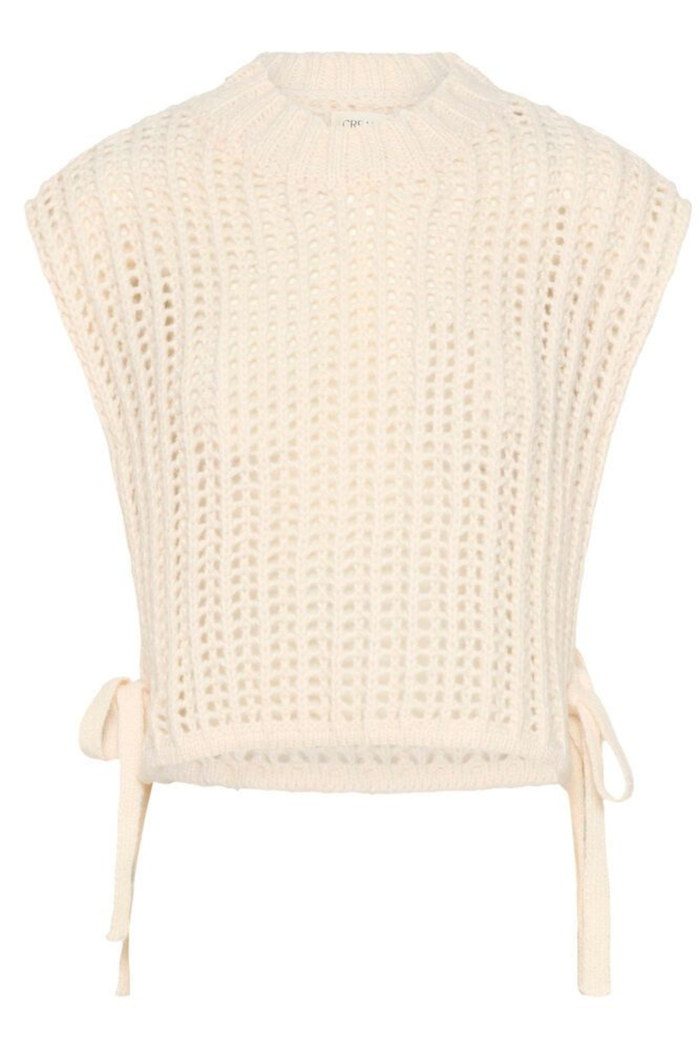 Lightweight open knit slipover in whisper white by Cream. Easy to layer with shirts or dresses for relaxed everyday style. Shop at Dotique.