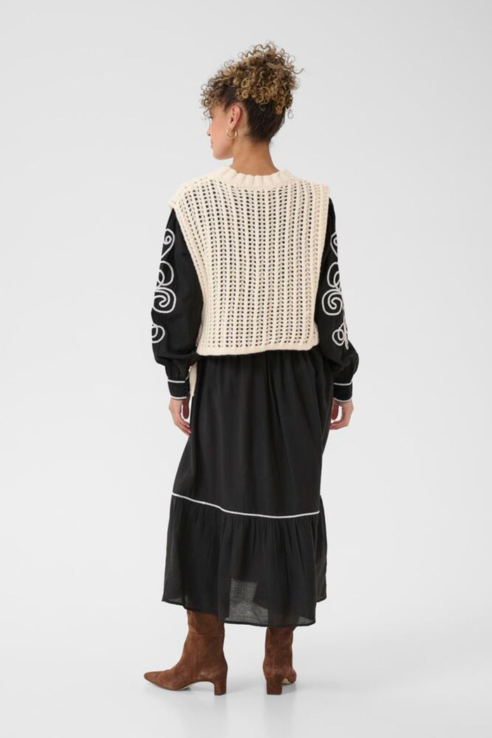 Lightweight open knit slipover in whisper white by Cream. Easy to layer with shirts or dresses for relaxed everyday style. Shop at Dotique.