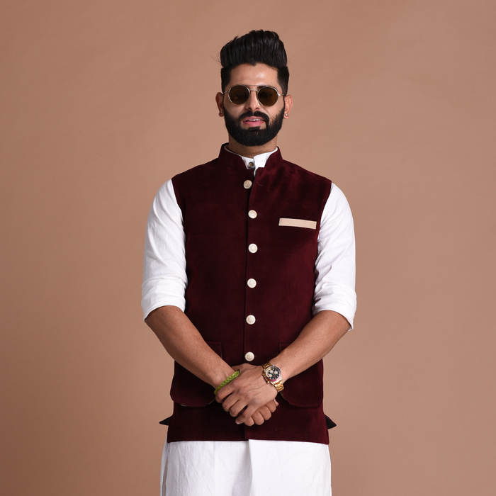 A man wearing a traditional half Jodhpuri jacket in maroon color
