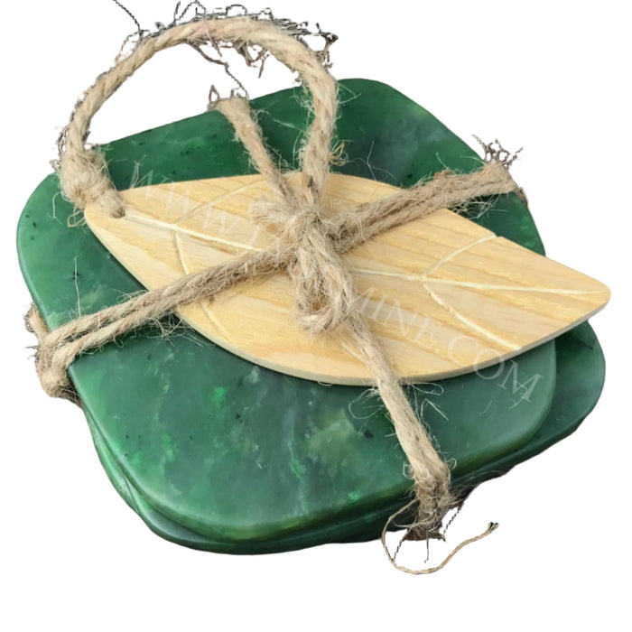 Green jade coasters with a wooden center and twine on a wooden surface
