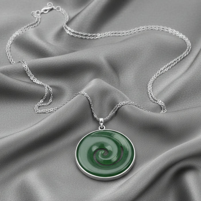 Necklace with a green jade circular pendant on a white background