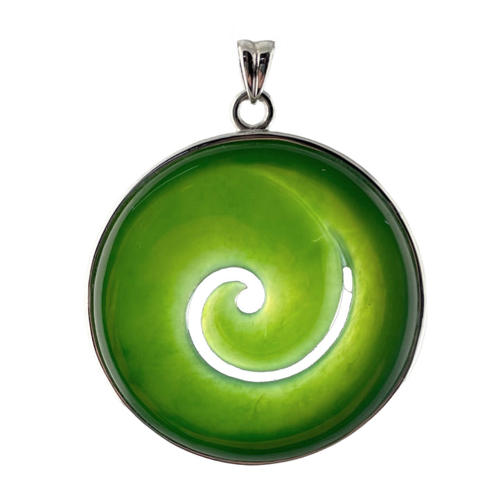 Green jade spiral pendant with silver setting on a white background