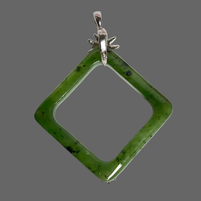 Green jade square pendant with silver chain on a white background