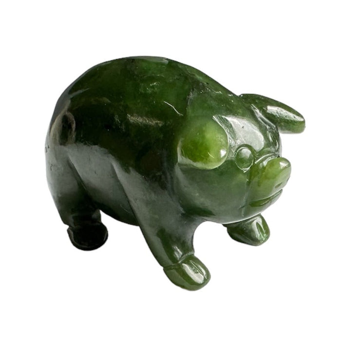 Green jade pig figurine on a white background