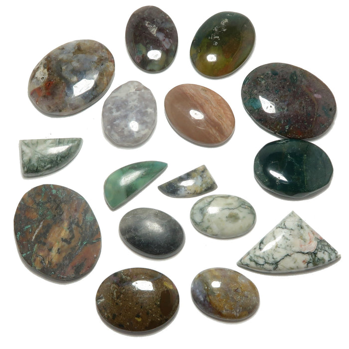 Collection of various polished gemstones on a white background