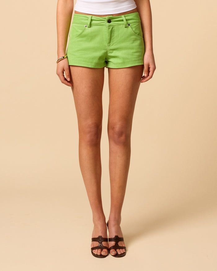 Women's mini low waisted corduroy shorts in kiwi-green featuring A-line fit.