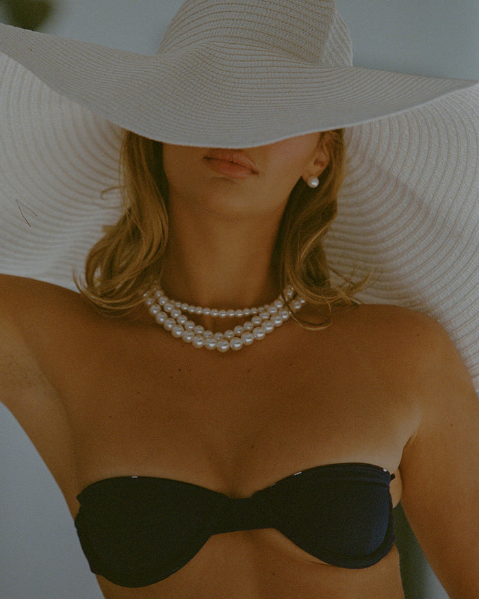 India reversible underwire bikini in navy polka dot with matte navy reverse, designed with removable halter straps and a tie-back for flexible wear.