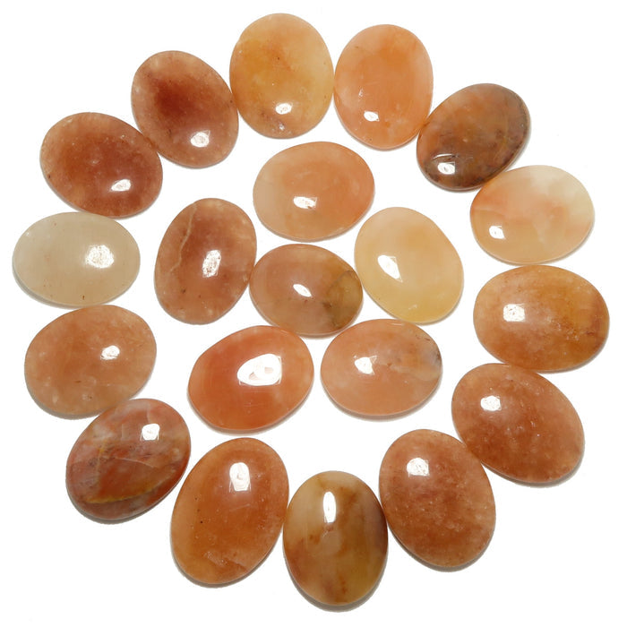 Collection of oval-shaped stones in various shades of brown and orange on a white background