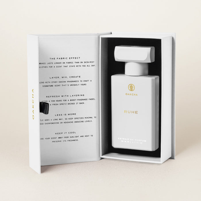 Front view of Ruhe Extrait de Parfum bottle in an open box with fabric layering and storage tips