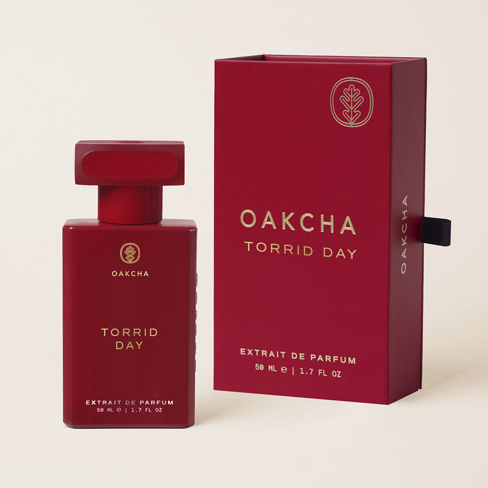 Front view of Torrid Day Extrait de Parfum bottle and box showcasing red packaging and 50 milliliter size on a beige background
