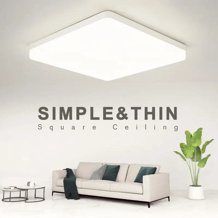 A white couch sitting in front of a white wall